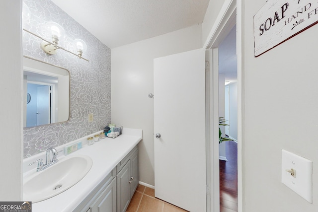 bathroom featuring tile patterned floors, vanity, and a textured ceiling