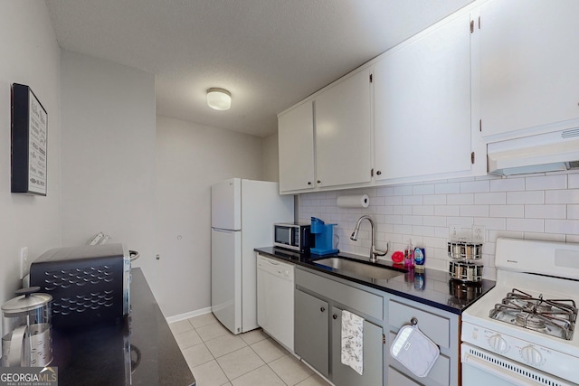 kitchen with sink, white cabinets, white appliances, and decorative backsplash