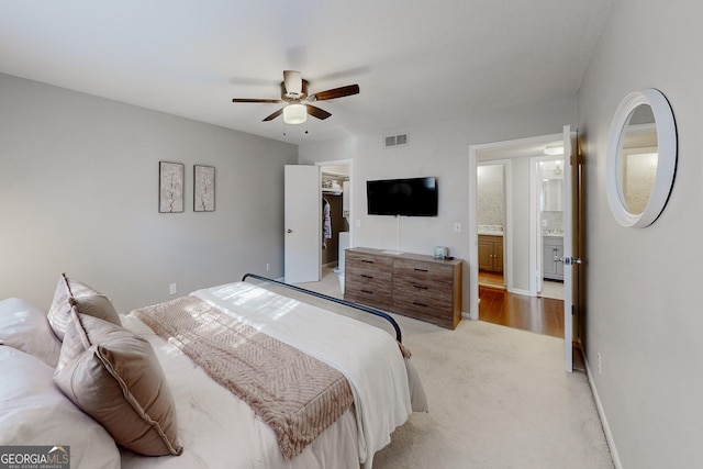 bedroom featuring light colored carpet and ceiling fan