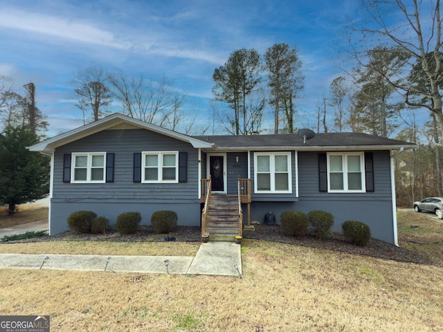 single story home with a front lawn