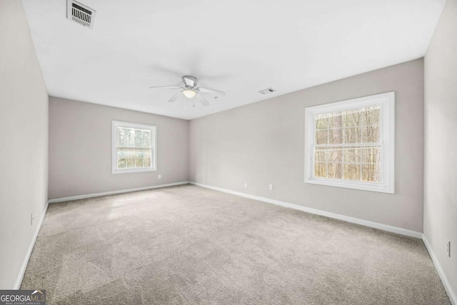 carpeted spare room with ceiling fan