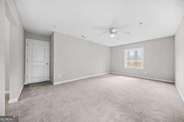 empty room featuring light carpet and ceiling fan