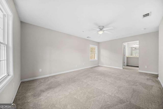 carpeted spare room with ceiling fan