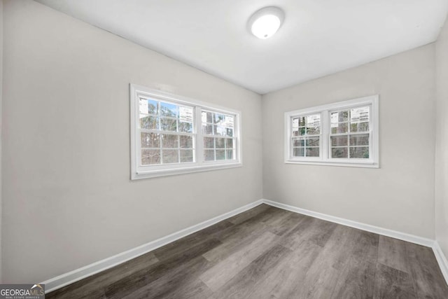 spare room with dark hardwood / wood-style flooring