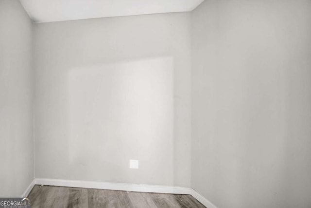 empty room with wood-type flooring