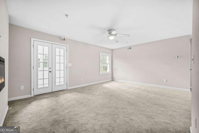 unfurnished living room featuring carpet floors, french doors, and ceiling fan