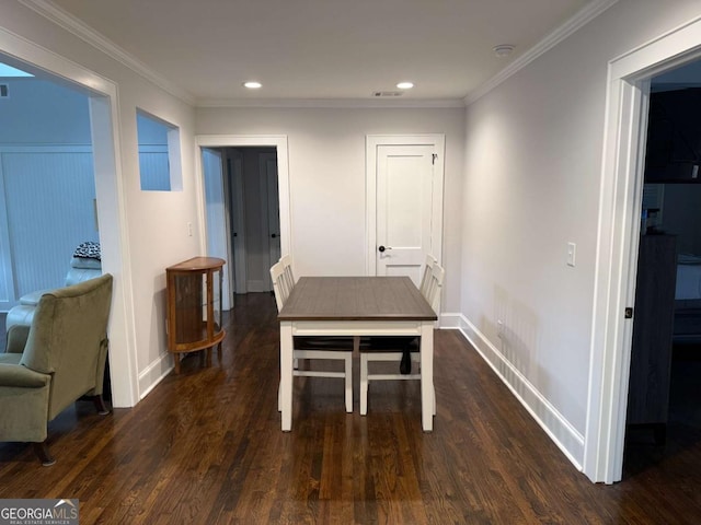 dining space with ornamental molding and dark wood-type flooring