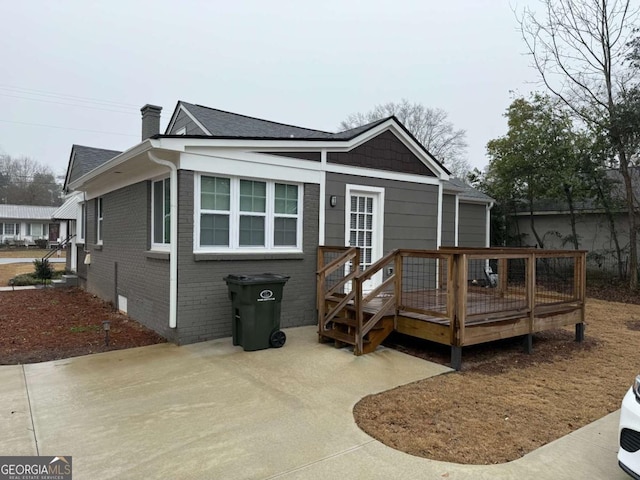 back of house featuring a wooden deck