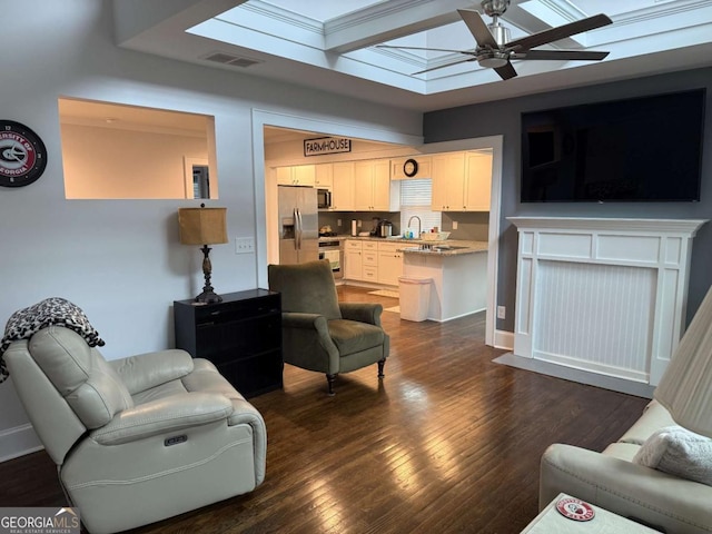 living room featuring dark wood-type flooring, ceiling fan, a skylight, and sink