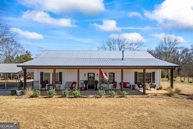 rear view of property featuring a porch