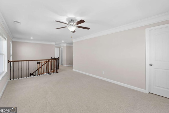 unfurnished room with light carpet, ceiling fan, and ornamental molding