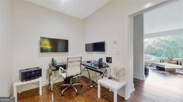 home office with baseboards, lofted ceiling, and wood finished floors