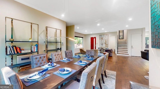 dining room featuring recessed lighting, stairway, and wood finished floors