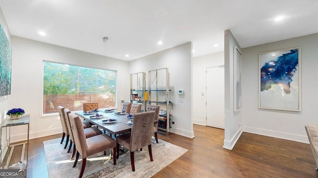 dining space featuring recessed lighting, baseboards, and wood finished floors