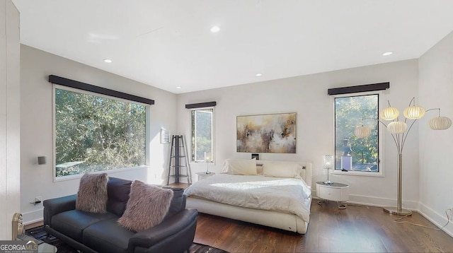 bedroom with recessed lighting, multiple windows, wood finished floors, and baseboards