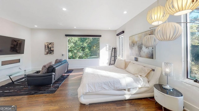 bedroom featuring recessed lighting, wood finished floors, and baseboards