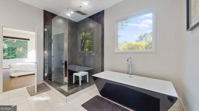 ensuite bathroom with tile patterned flooring, a shower stall, ensuite bathroom, and a freestanding tub