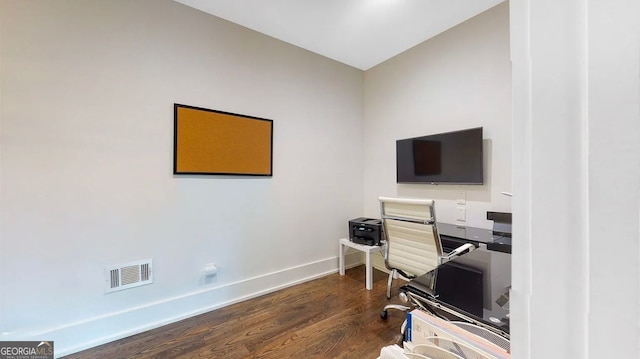 office area featuring dark wood-type flooring, baseboards, and visible vents