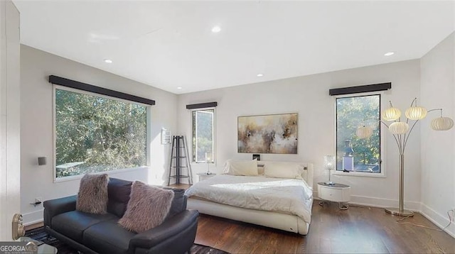 bedroom with recessed lighting, wood finished floors, and baseboards