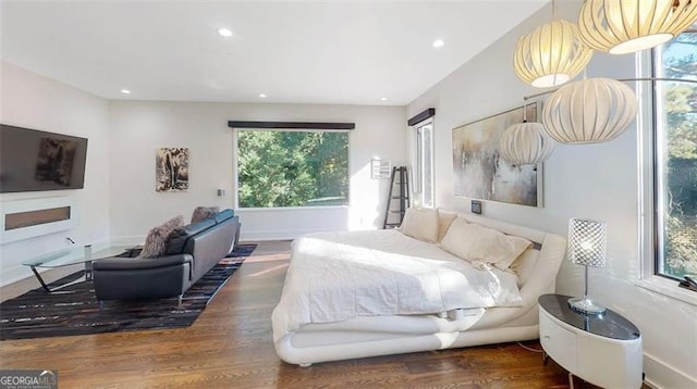 bedroom with recessed lighting, baseboards, and wood finished floors