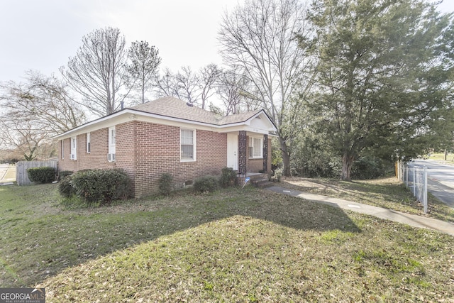 view of side of property with a yard