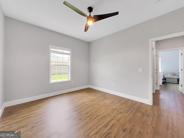 empty room with ceiling fan and wood-type flooring