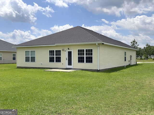 rear view of house featuring a patio and a lawn