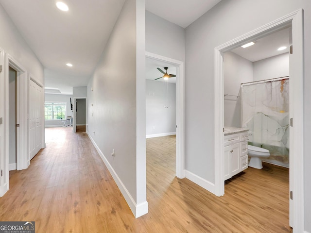 hallway with light hardwood / wood-style floors