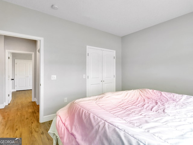 bedroom featuring a closet and light hardwood / wood-style floors