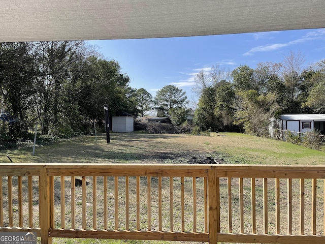 wooden deck featuring a yard