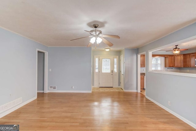 entryway featuring plenty of natural light, light wood-style flooring, and visible vents