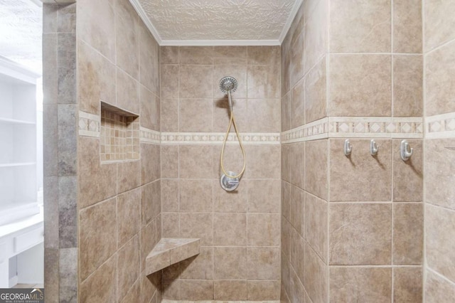 full bathroom featuring a textured ceiling and tiled shower