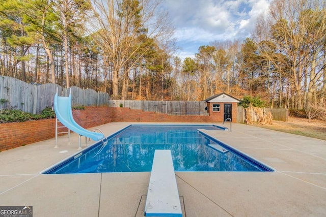 view of swimming pool with a fenced in pool, a fenced backyard, a water slide, an outdoor structure, and a patio area