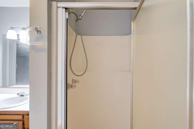 bathroom featuring a shower stall and vanity