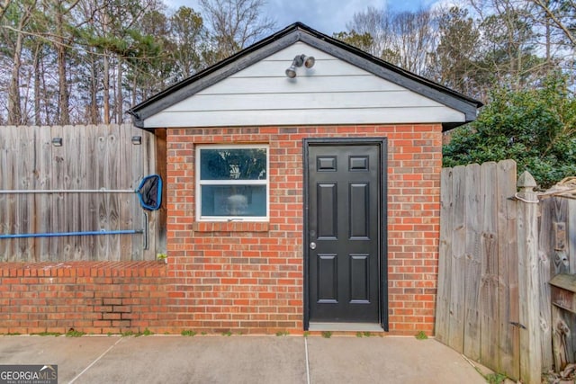 view of outbuilding featuring fence