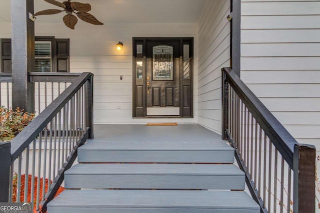 view of exterior entry featuring a porch and a ceiling fan