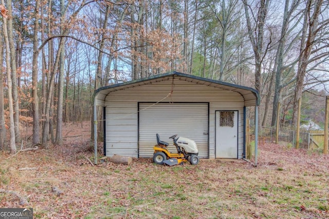 view of outbuilding featuring an outbuilding and fence