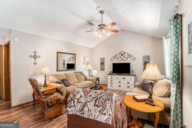 living room featuring wood-type flooring, lofted ceiling, and ceiling fan