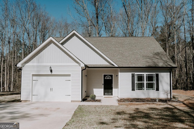 view of front of home with a garage and a front lawn