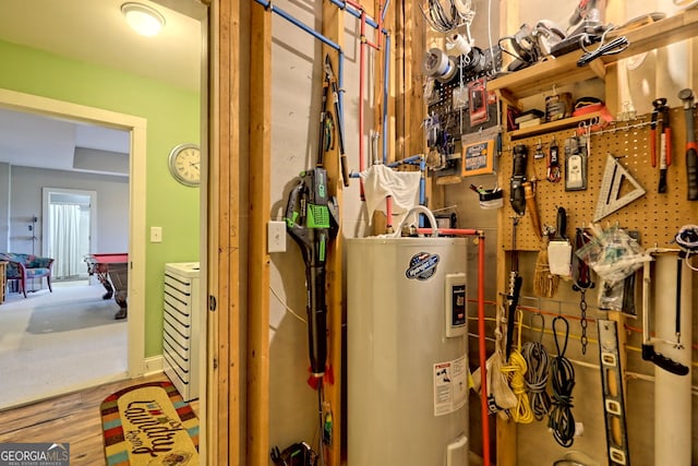 utility room featuring water heater