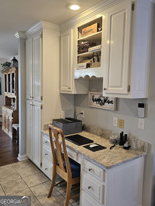 tiled office space with built in desk and ornamental molding