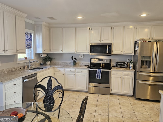 kitchen featuring sink, white cabinets, light tile patterned floors, light stone counters, and stainless steel appliances