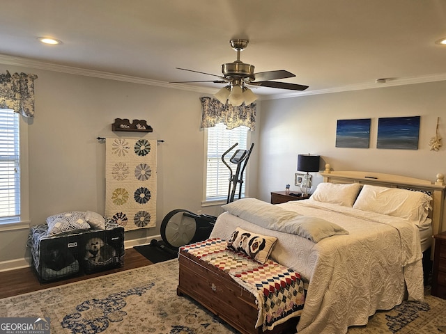 bedroom featuring crown molding, dark wood-type flooring, and ceiling fan