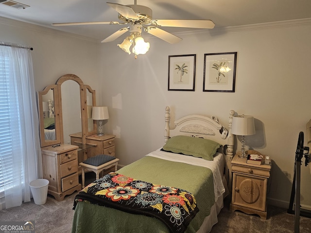 carpeted bedroom featuring crown molding and ceiling fan