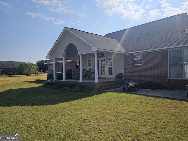 view of front of house with a patio and a front yard