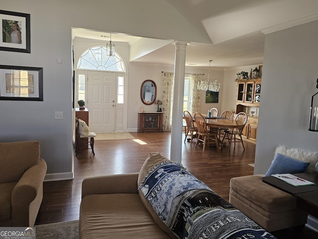 living room featuring crown molding, lofted ceiling, dark hardwood / wood-style floors, and ornate columns