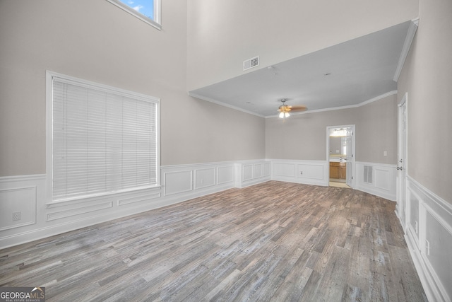 interior space featuring ornamental molding, hardwood / wood-style floors, and ceiling fan