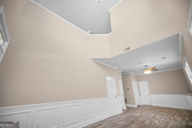 interior space with crown molding, ceiling fan, and hardwood / wood-style floors