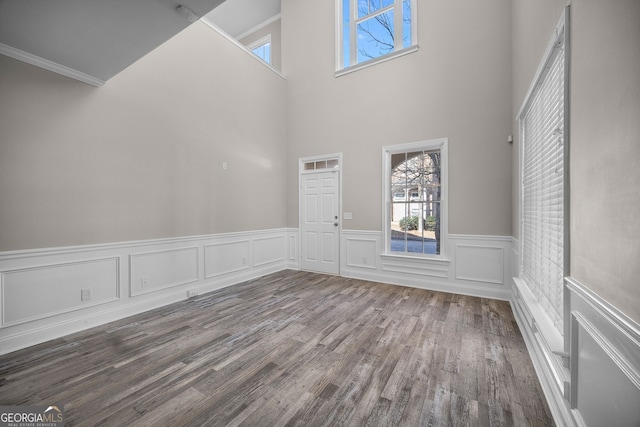 interior space with wood-type flooring and crown molding