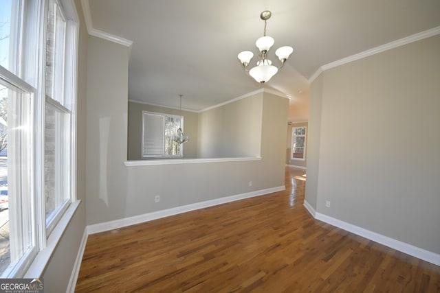 empty room with an inviting chandelier, crown molding, and dark wood-type flooring